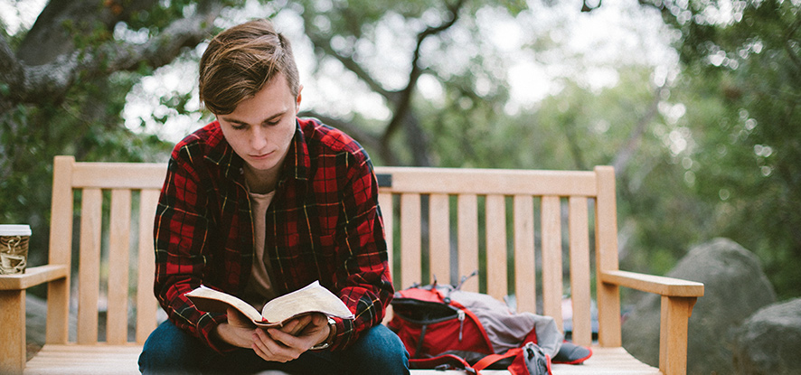Student reading a bible